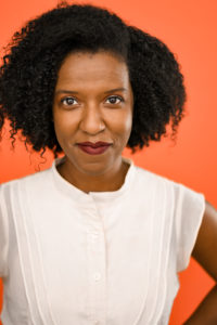 Picture of LaTanya Lane in a white shirt with an orange background and a smile on her face